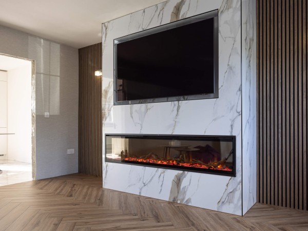 odern TV feature wall in an Irish living room featuring oak acoustic slatted wood panelling and a wall-mounted Smart TV with hidden cable management.